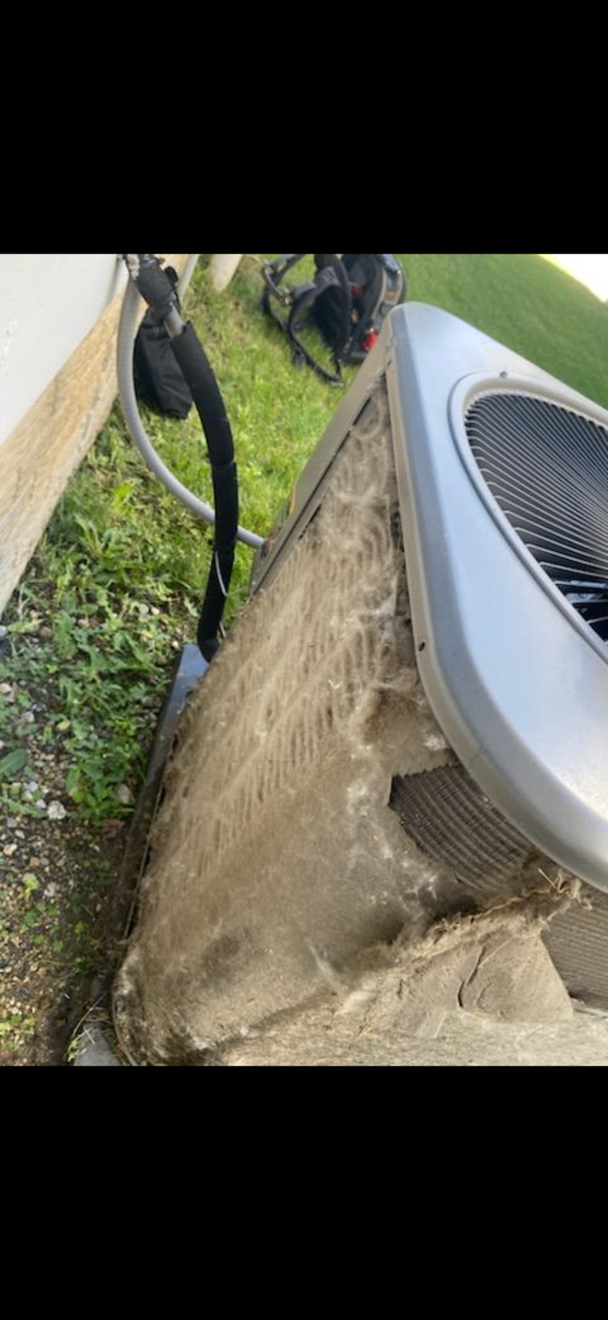 Before: close-up of dirt and debris matted across the condenser coil fins